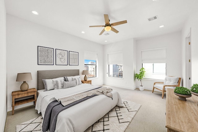 bedroom with visible vents, baseboards, a ceiling fan, light colored carpet, and recessed lighting