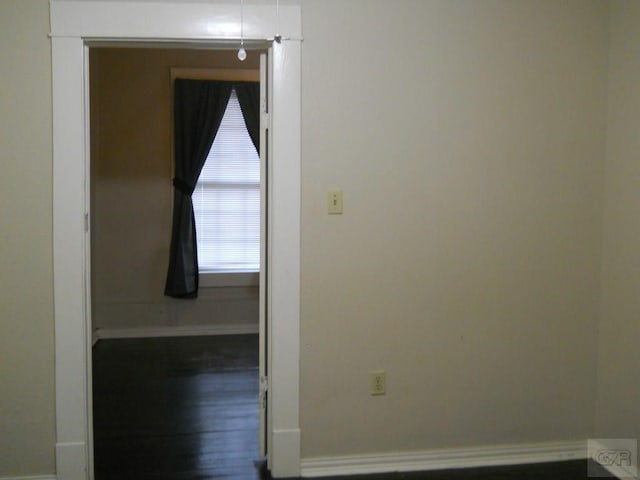 hallway with dark hardwood / wood-style flooring