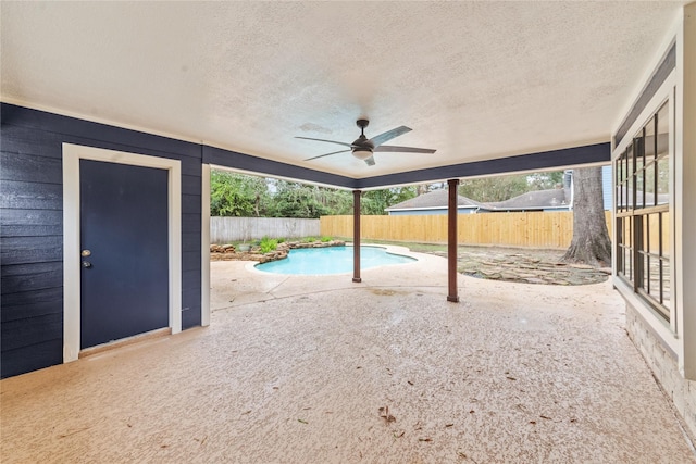 view of swimming pool with ceiling fan and a patio