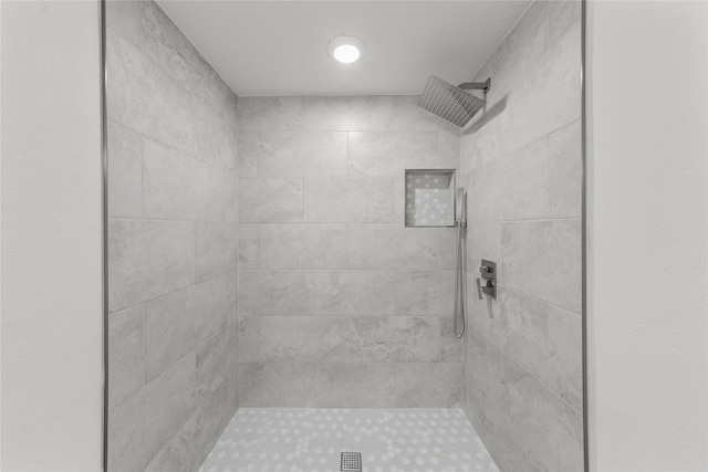 bathroom with tiled shower