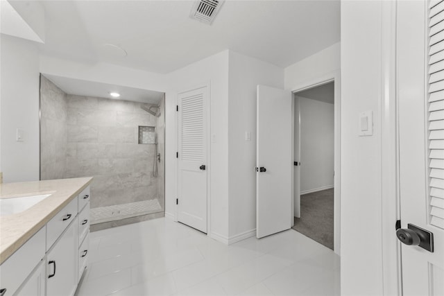 bathroom featuring vanity and tiled shower