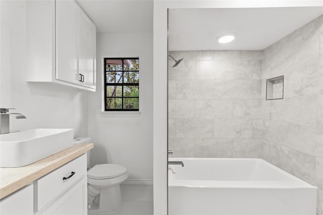 full bathroom with toilet, vanity, and tiled shower / bath