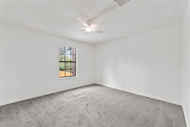 unfurnished room with ceiling fan and carpet flooring