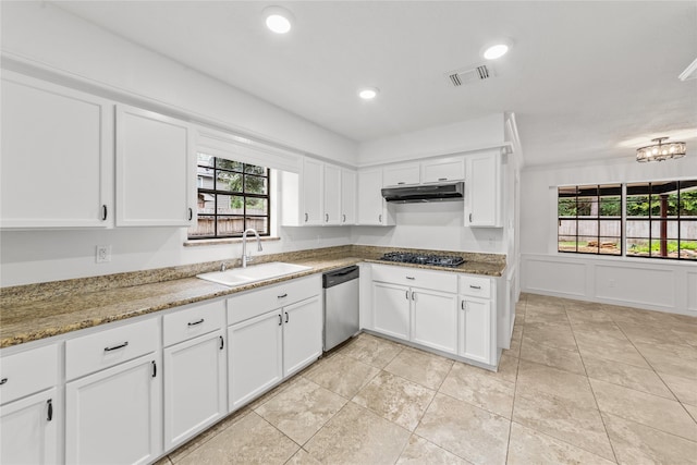 kitchen featuring sink, dishwasher, white cabinetry, and light stone counters