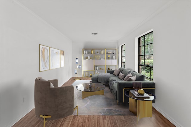 living room featuring hardwood / wood-style flooring and ornamental molding