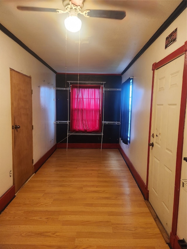 unfurnished dining area featuring baseboards, ornamental molding, and wood finished floors