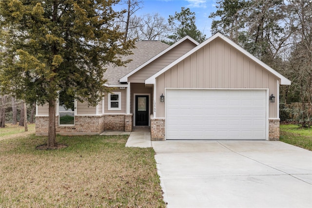 view of front of home featuring a garage, brick siding, driveway, roof with shingles, and a front yard