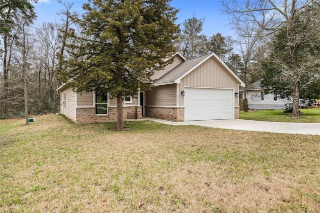 view of front of house with an attached garage, concrete driveway, brick siding, and a front yard