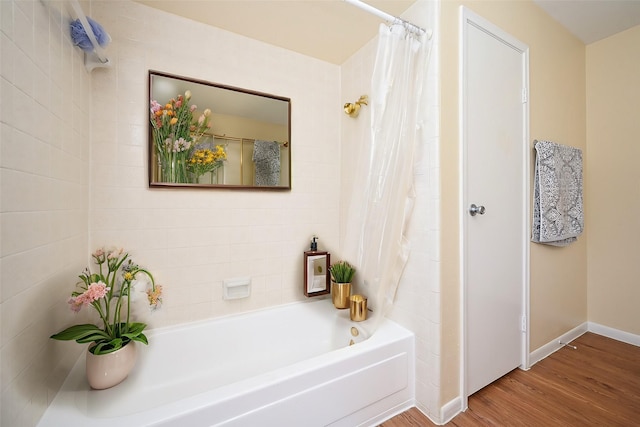 bathroom with shower / bathtub combination with curtain and wood-type flooring