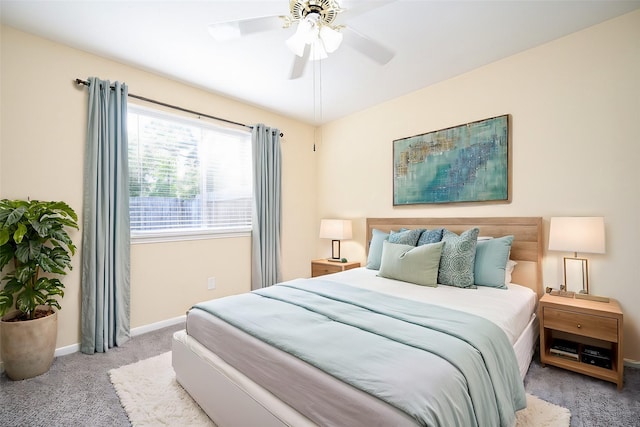 bedroom featuring light colored carpet and ceiling fan