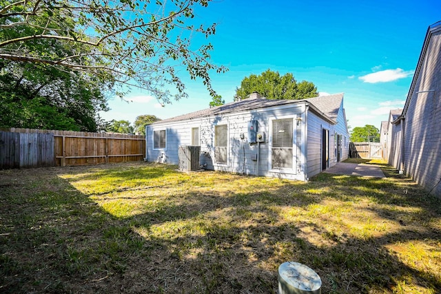 rear view of house with a yard