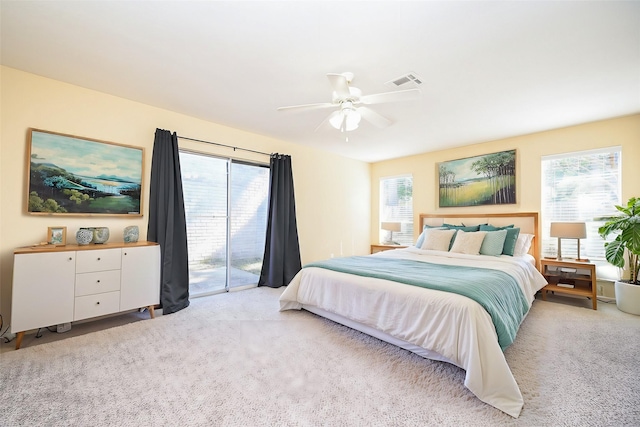 bedroom featuring light carpet, multiple windows, and access to exterior