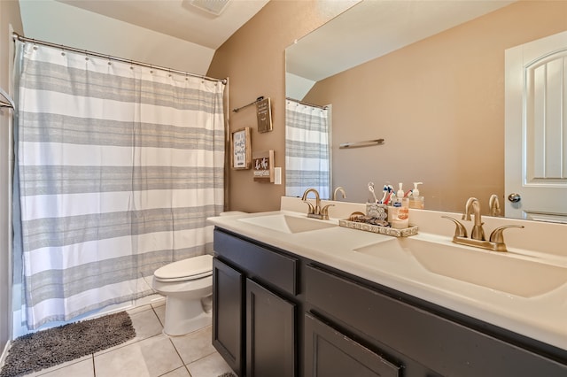 full bath with double vanity, a sink, toilet, and tile patterned floors