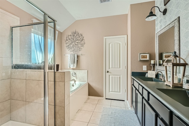 full bathroom with a garden tub, a stall shower, vaulted ceiling, a sink, and tile patterned floors