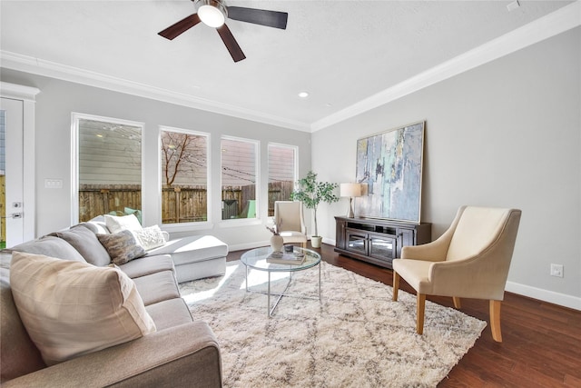 living area featuring baseboards, ceiling fan, ornamental molding, dark wood-style flooring, and recessed lighting