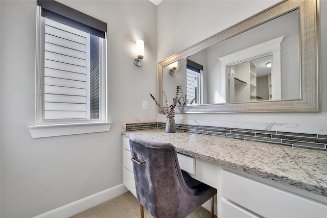 bathroom with baseboards and vanity