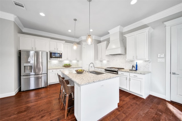 kitchen featuring stainless steel appliances, white cabinets, and custom exhaust hood