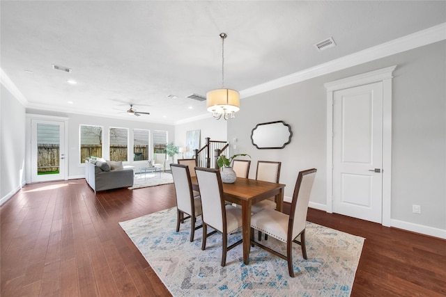 dining area featuring crown molding, visible vents, and dark wood finished floors