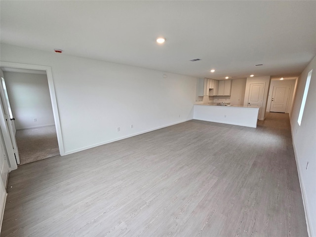 unfurnished living room featuring light wood-type flooring