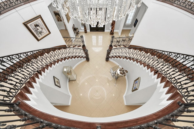 stairs with a chandelier