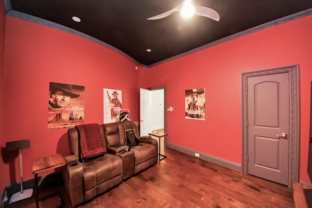 home theater room with ceiling fan and wood-type flooring