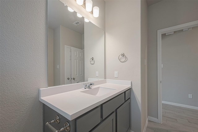 bathroom with hardwood / wood-style flooring and vanity