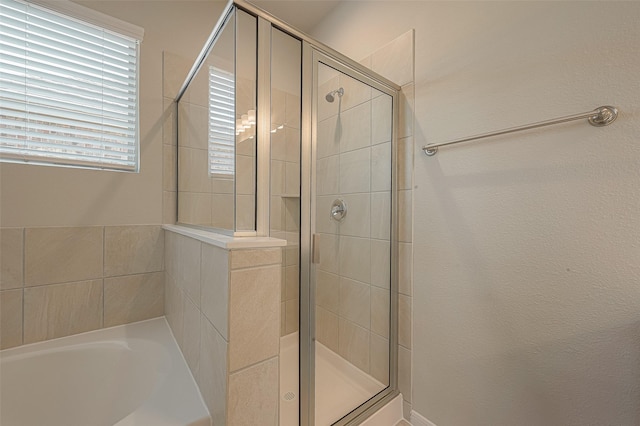 bathroom with separate shower and tub