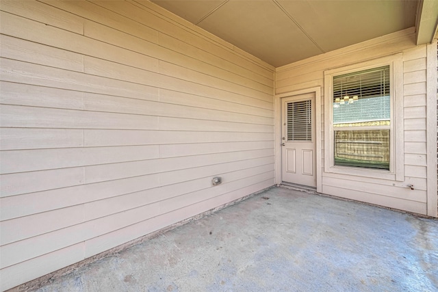 view of exterior entry featuring a patio area