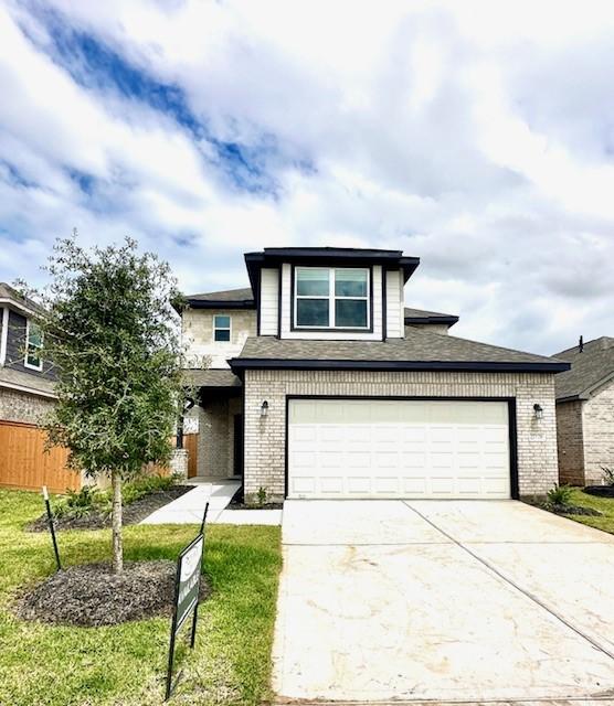 view of front of home featuring a garage and a front lawn