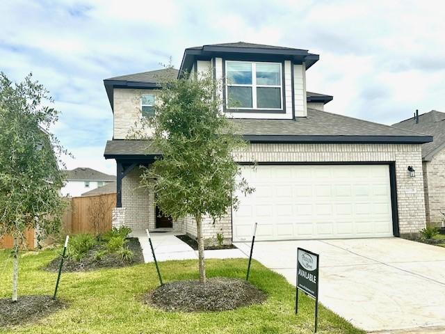 view of front facade featuring a front yard and a garage