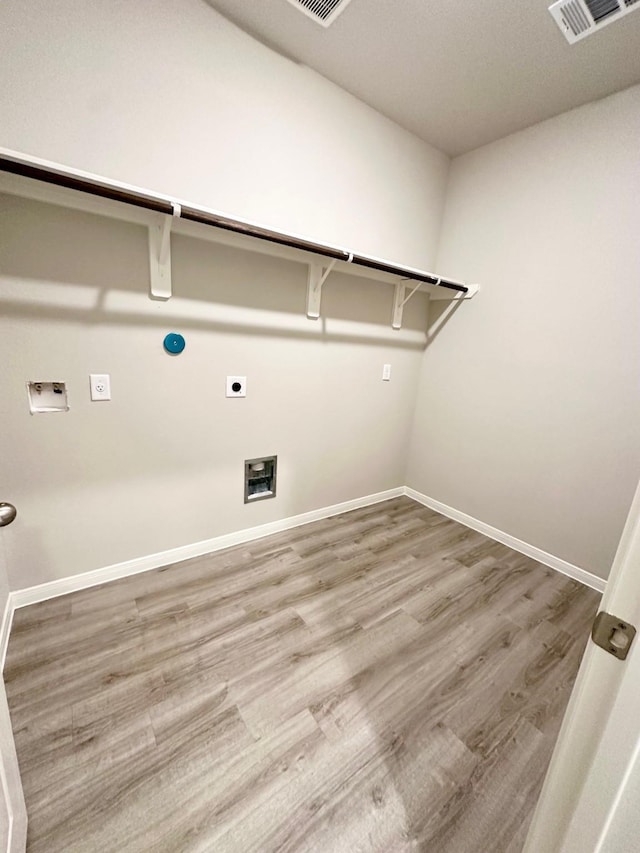 laundry area with wood-type flooring, electric dryer hookup, and hookup for a washing machine