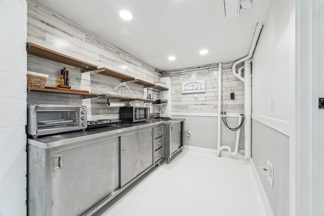 kitchen with a toaster, open shelves, recessed lighting, stainless steel microwave, and a sink