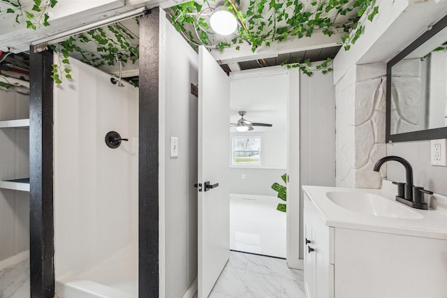 full bath featuring a stall shower, marble finish floor, ceiling fan, and vanity