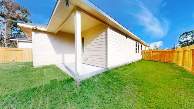 view of side of property featuring a patio area and a yard