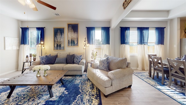 living room featuring a wealth of natural light, ceiling fan, and hardwood / wood-style flooring