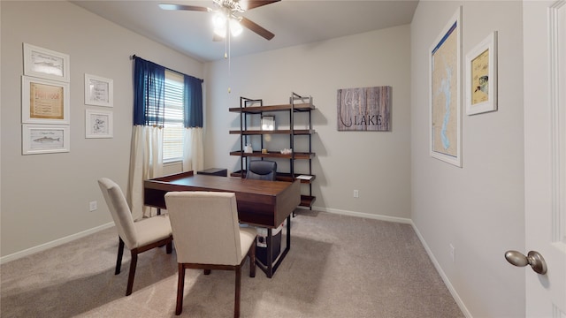 dining area with ceiling fan and light carpet