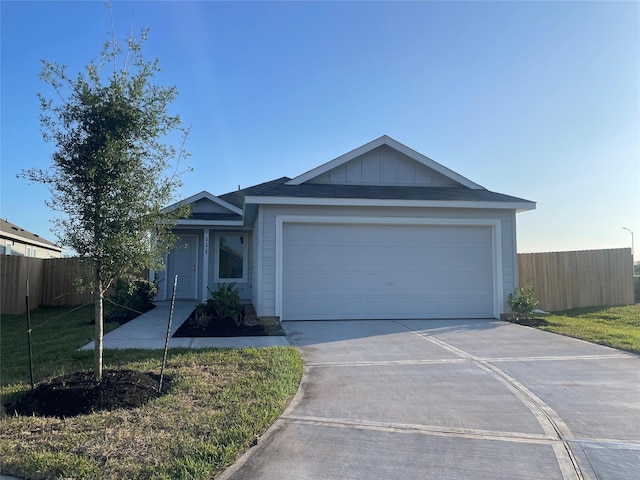 single story home featuring an attached garage, concrete driveway, and fence