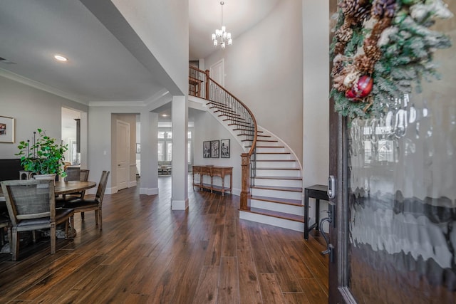 foyer entrance featuring crown molding, stairs, baseboards, and dark wood-style flooring