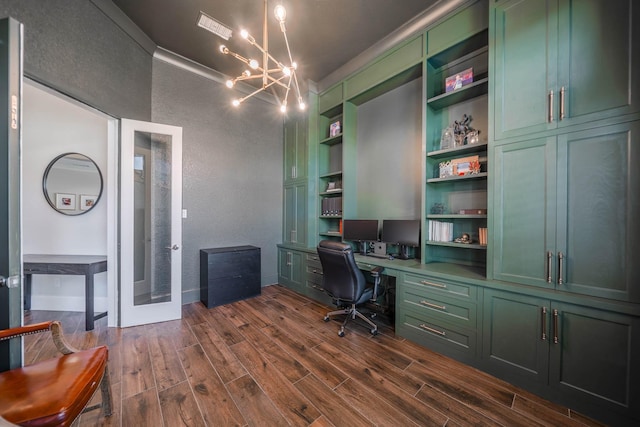 office space with a chandelier, dark wood-style flooring, built in study area, and a textured wall