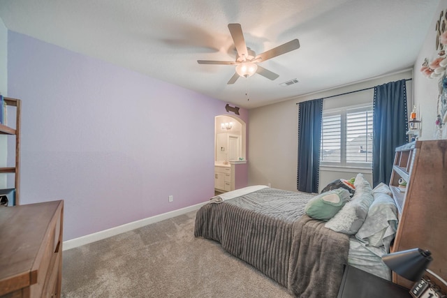 bedroom featuring baseboards, visible vents, arched walkways, ceiling fan, and carpet flooring