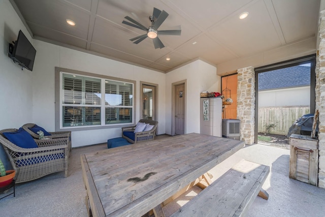 view of patio with ceiling fan and fence