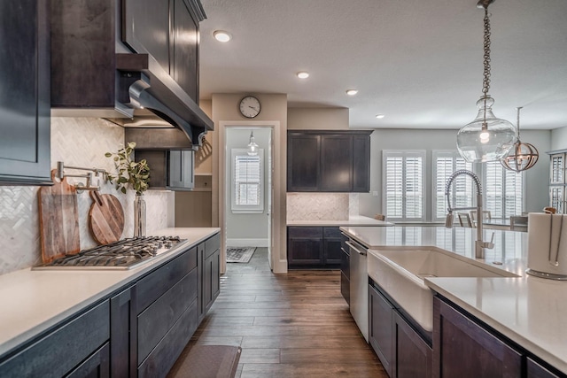 kitchen with light countertops, appliances with stainless steel finishes, and a sink