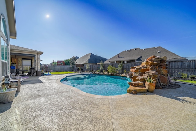 view of swimming pool with a fenced in pool, a fenced backyard, and a patio