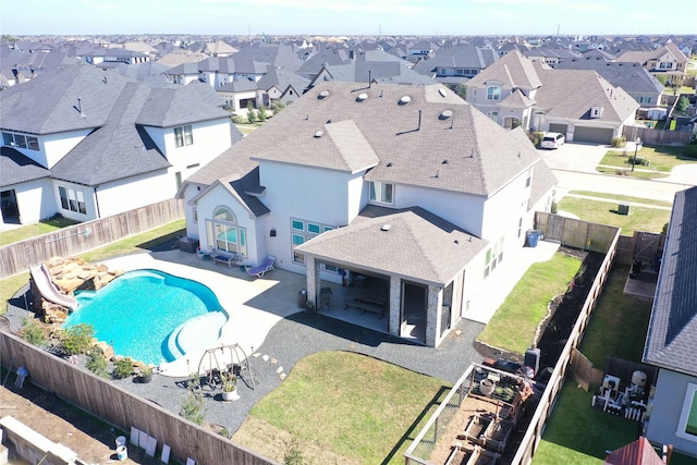 view of pool featuring a fenced in pool, a patio area, a residential view, a water slide, and a fenced backyard