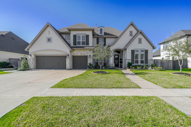 french country inspired facade featuring stucco siding, concrete driveway, fence, a garage, and a front lawn