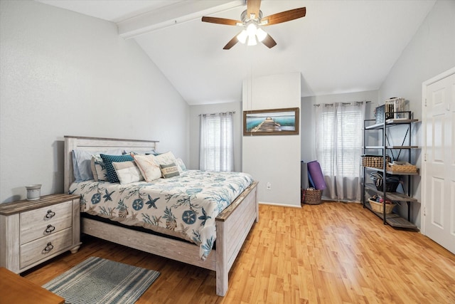 bedroom with lofted ceiling with beams, light wood finished floors, multiple windows, and a ceiling fan