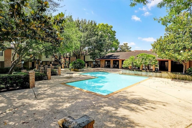 community pool with a patio area