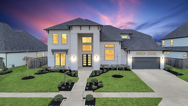 view of front of house featuring a yard and a garage