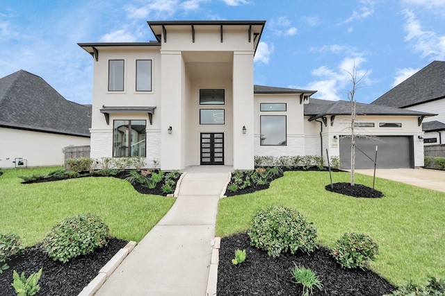 view of front of house with a garage and a front lawn