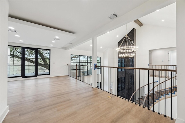 corridor featuring high vaulted ceiling, light hardwood / wood-style flooring, beamed ceiling, and a notable chandelier